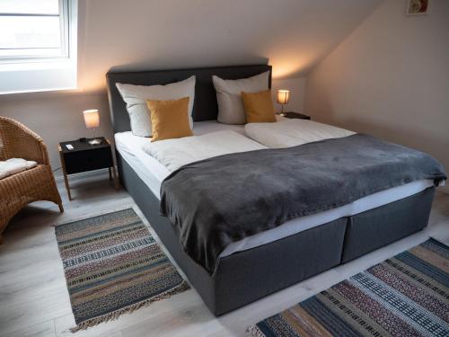 a bedroom with a large bed with pillows at Mühlberg, Ferienwohnung in Schneverdingen