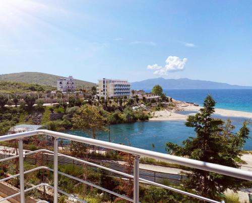 a view of a beach from a balcony at RiverSea Apartment Saranda in Sarandë