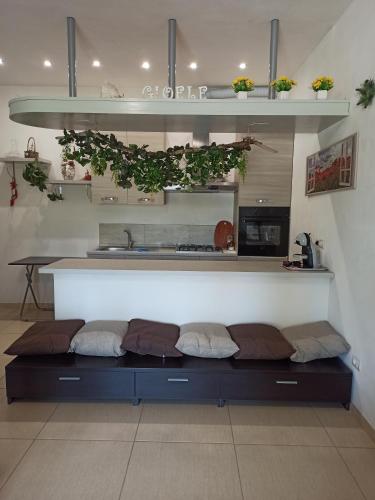 a kitchen with a bench in a room with plants at Gio.Ele in Melendugno