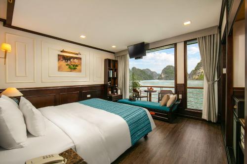 a hotel room with a bed and a large window at Orchid Trendy Cruise in Ha Long