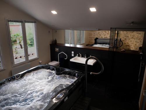 a bathroom with a large tub and a sink at Château Fleur D'Aya in Artigues-près-Bordeaux