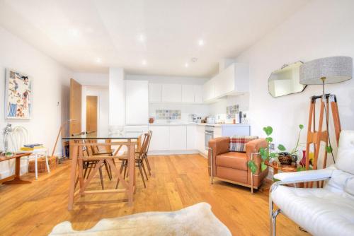 a kitchen and living room with a table and chairs at Lyme Time in Lyme Regis