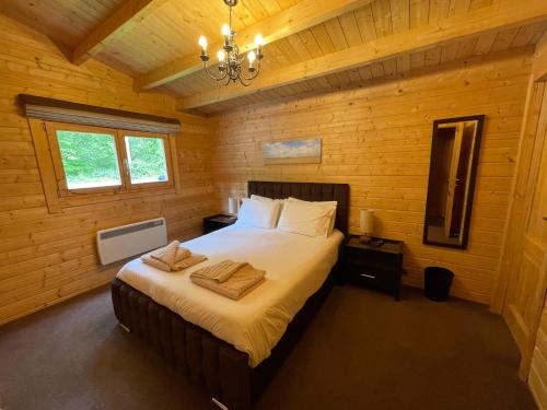 a bedroom with a large bed in a wooden room at iLodge 73 in Louth