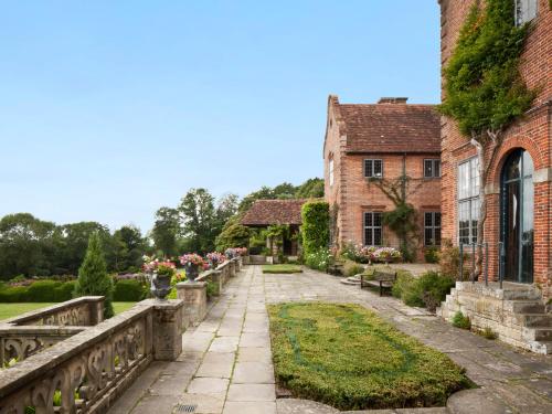 a bridge over a garden next to a building at Port Lympne Mansion Hotel in Hythe
