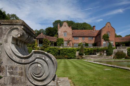 a stone bench in front of a house at Port Lympne Mansion Hotel in Hythe