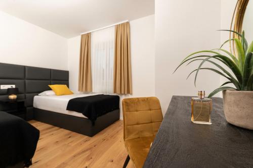 a bedroom with a bed and a table and a chair at Villa Pafran with heated pool Krk in Krk