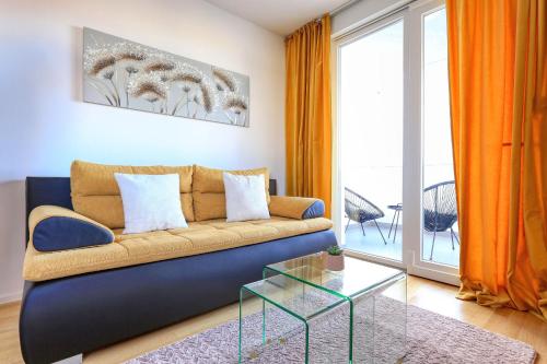 a living room with a couch and a glass table at Barbara with private parking in the garage in Zadar