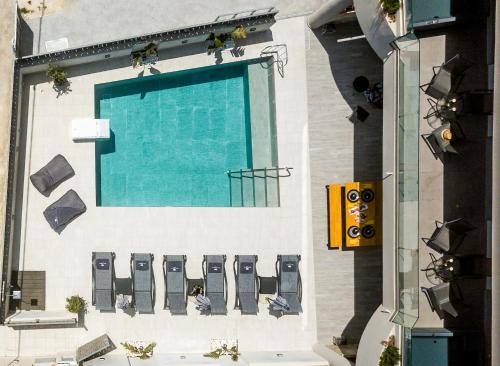 an overhead view of a swimming pool on a building at Old Cinema Suites - Stylishly Decorated Retreat with Pool or Jacuzzi by the Sea in the Heart of Laganas Βy Villa Mana Gers in Laganas