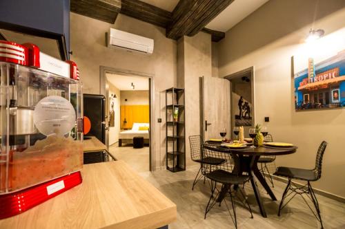 a dining room with a table and chairs in a room at Old Cinema Suites - Stylishly Decorated Retreat with Pool or Jacuzzi by the Sea in the Heart of Laganas Βy Villa Mana Gers in Laganas