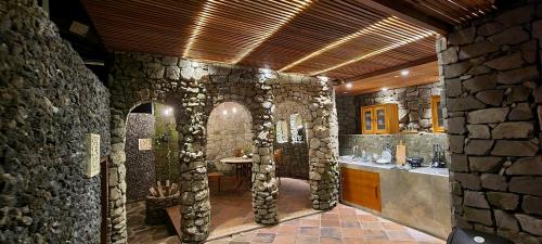 a large stone bathroom with a stone wall at Avalon Ubud Castle & SPA in Ubud