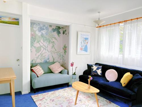 a living room with a couch and a table at Shan Mu Inn Entire flat 2 bedrooms with terrace seaview in Newlyn
