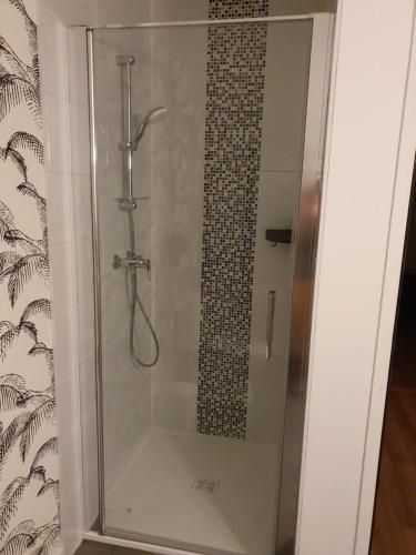 a shower in a bathroom with a glass door at Gite la forge à Liéhon in Liéhon