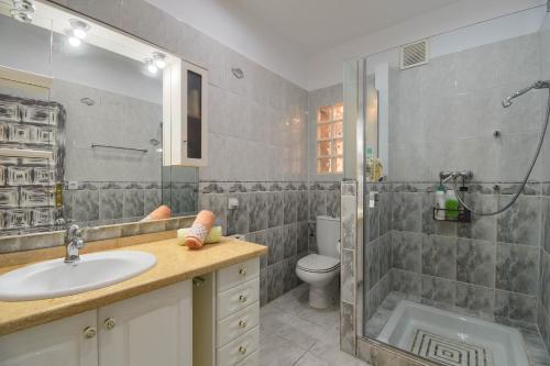 a bathroom with a sink and a shower and a toilet at Villa Dulce Cala Baladrar in Benissa