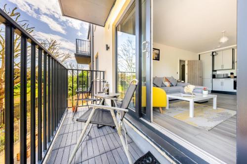 a balcony with a view of a living room at Ash View Place 3 -Heathrow - Thorpe Park - Free Parking in Staines