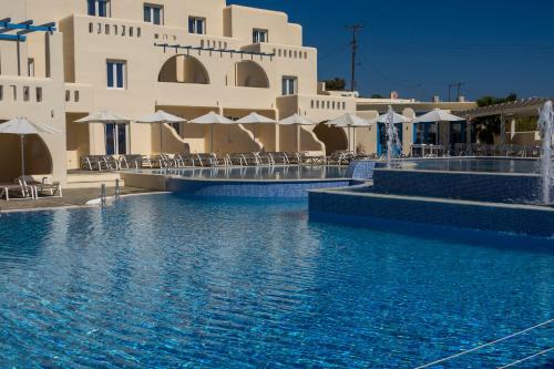 a swimming pool in front of a building at Naxian Emerald Hotel in Naxos Chora