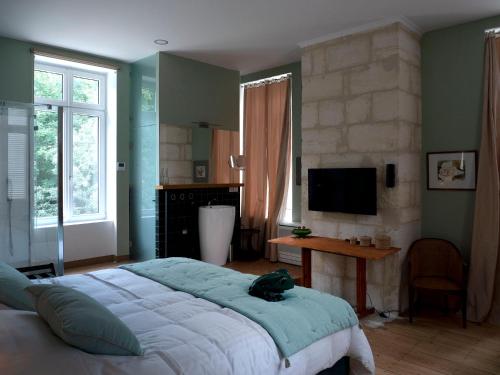 Ένα ή περισσότερα κρεβάτια σε δωμάτιο στο Château Fleur D'Aya