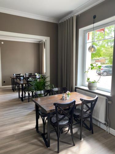 a dining room with tables and chairs and a window at Villa Granliden in Ludvigsborg