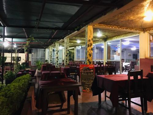 a restaurant with tables and chairs in a room at Les flots Bleu in Antananarivo