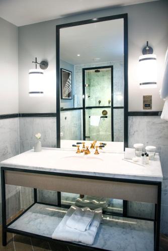 a bathroom with a sink and a mirror at voco Grand Central Glasgow by IHG in Glasgow