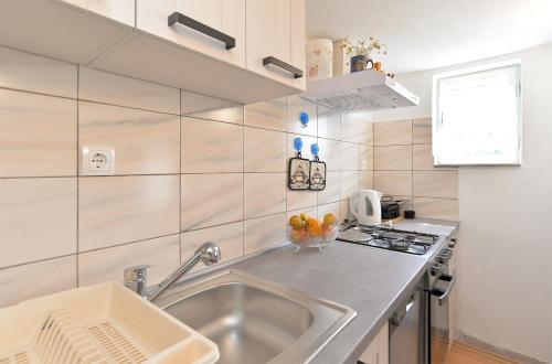 a small kitchen with a sink and a stove at Apartment Boris 2161 in Pula