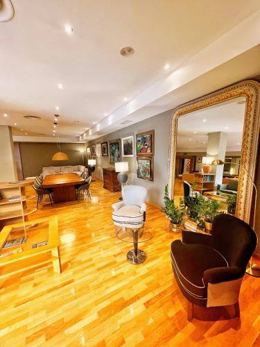 a living room with a large mirror and a table at Mercure Carlton Rioja in Logroño