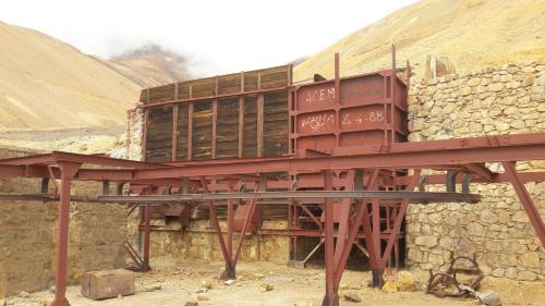 a red train sitting on top of a stone wall at Cuesta de san miguel in Chilecito