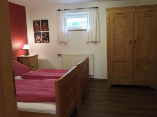 a bedroom with a bed and a window at Haus Pollak in Waldkirchen