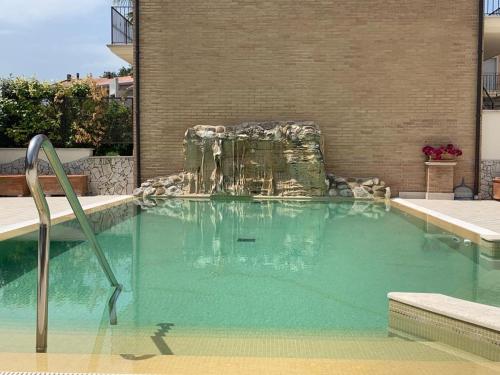 a swimming pool with a fountain in a building at il borghetto Bennie en Liisa in Cupra Marittima