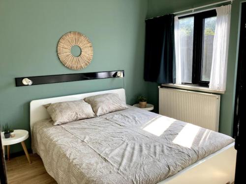 a bedroom with a bed with a mirror on the wall at Holiday home Beachy Days near ocean & lake in Noordwijkerhout