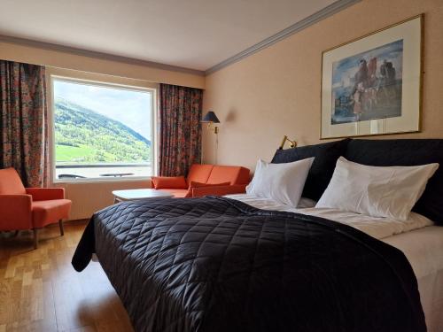 A bed or beds in a room at Olden Fjordhotel