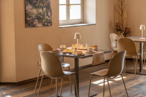 a dining room with chairs and a table with food on it at Il Pradicciolo Agriturismo in Castelnuovo di Garfagnana