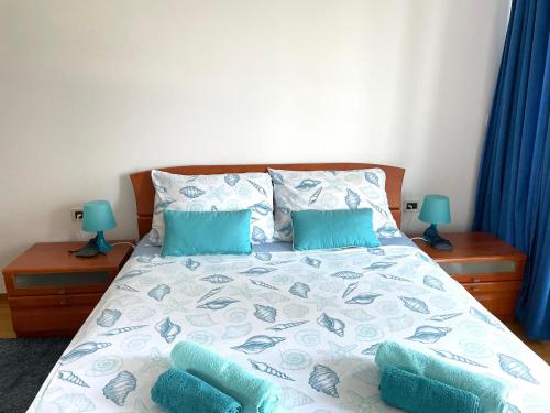 a bedroom with a bed with blue pillows at Apartment Toni in Ičići