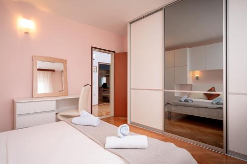 a bedroom with a large mirror and a bed at Spacious Green Home in Hvar