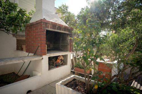 a person is looking out of a brick oven at Spacious Green Home in Hvar