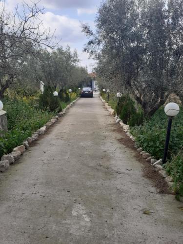 a road with a car parked on the side at Oasi in Salamina