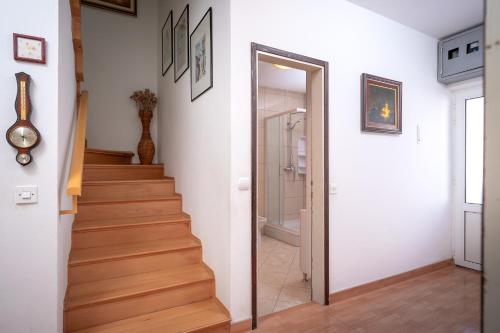 a hallway with a stairway leading up to a room at Spacious Green Home in Hvar