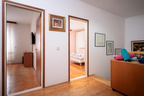 a hallway with a mirror in a room at Spacious Green Home in Hvar