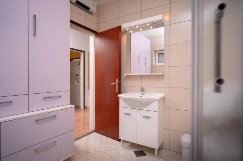 a bathroom with a sink and a mirror at Spacious Green Home in Hvar
