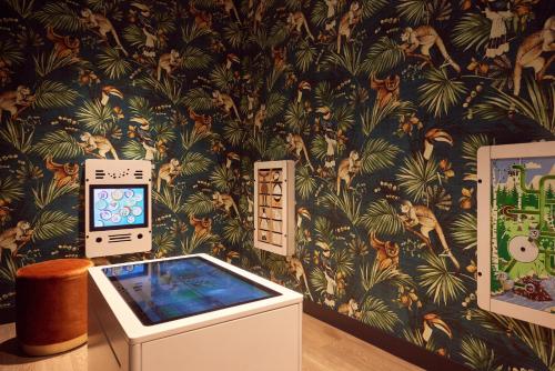 a room with a wall with a tropical wallpaper at Van der Valk Hotel Arnhem in Arnhem