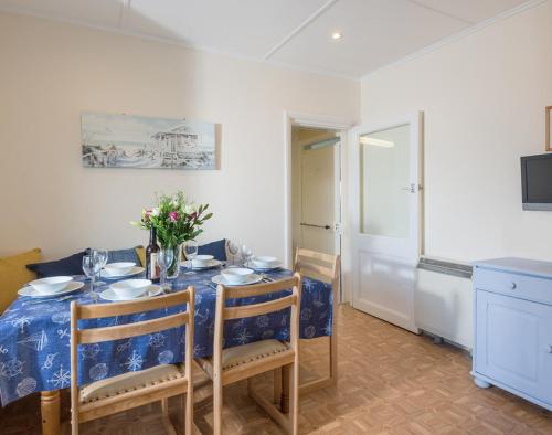 a dining room table with a blue and white table cloth at Hillcroft Bungalow in Polzeath