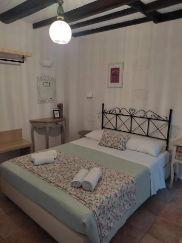 a bedroom with a large bed with two pillows on it at Loggia Traditional Suites in Rethymno Town