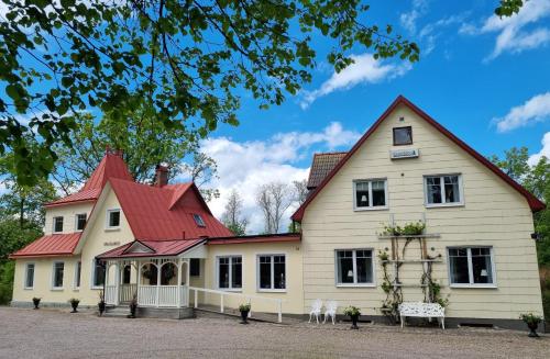 a large white house with a red roof at Villa Granliden in Ludvigsborg