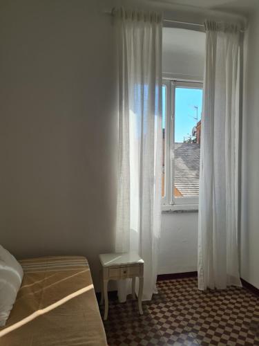 a bedroom with a bed and a window at Casetta in Centro, a Chiavari, by Cinqueterrecoast in Chiavari
