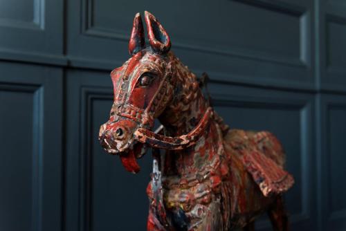a figurine of a horse statue in front of a wall at La Maison Pavie in Dinan