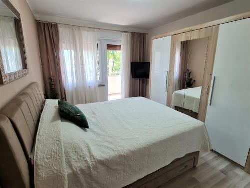 a bedroom with a bed and a television in it at M & M Apartment in Pula