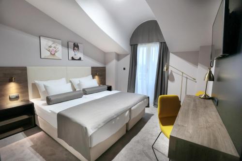 Postel nebo postele na pokoji v ubytování Hotel Milenij