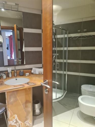 a bathroom with a glass shower and a sink at Albergo Del Lago in Cannobio