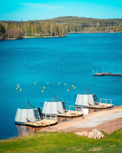 three boats sitting on the shore of a lake at Spa Hotel Kunnonpaikka in Kuopio