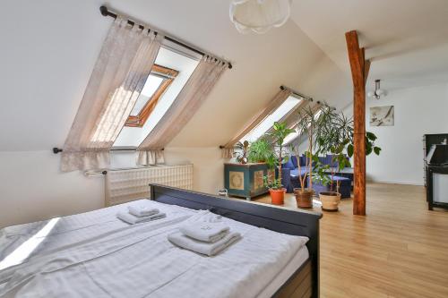 a bedroom with a bed with two towels on it at Pension Dáša in Tábor