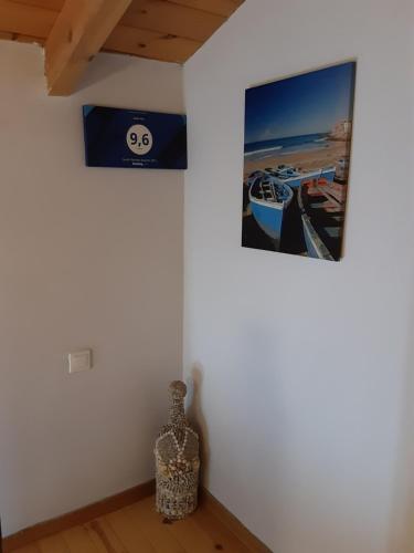 a room with two pictures on the wall and a vase at Dioni Villa in Sivota